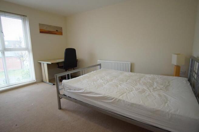 A bright and airy double bedroom featuring a co...