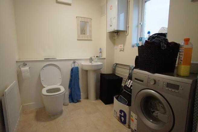 Functional bathroom with a toilet and corner si...