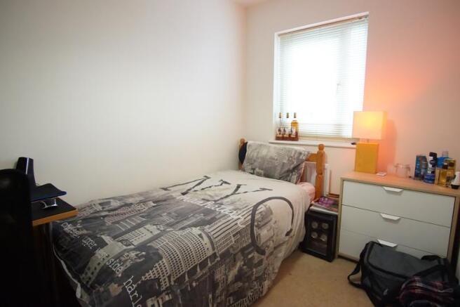 Bright, simply furnished double bedroom with a ...