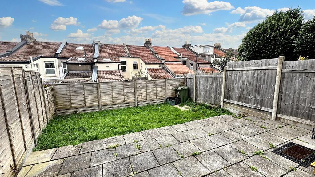 Sunny rear garden with a paved patio area leadi...
