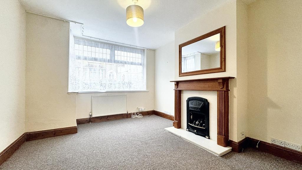 Bright, neutrally decorated living room with a ...