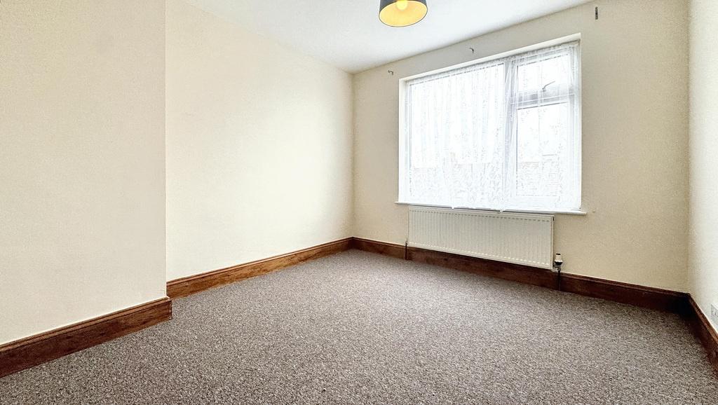 Bright, neutral double bedroom with a large win...