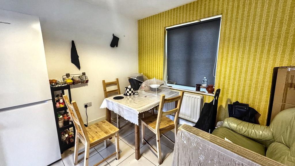 Bright compact kitchen/dining area with a dinin...