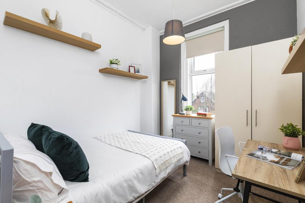 A cozy and well-maintained bedroom with natural...