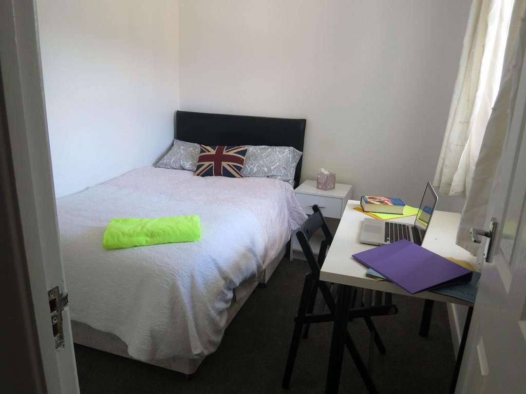 A well-lit double bedroom featuring a comfortab...
