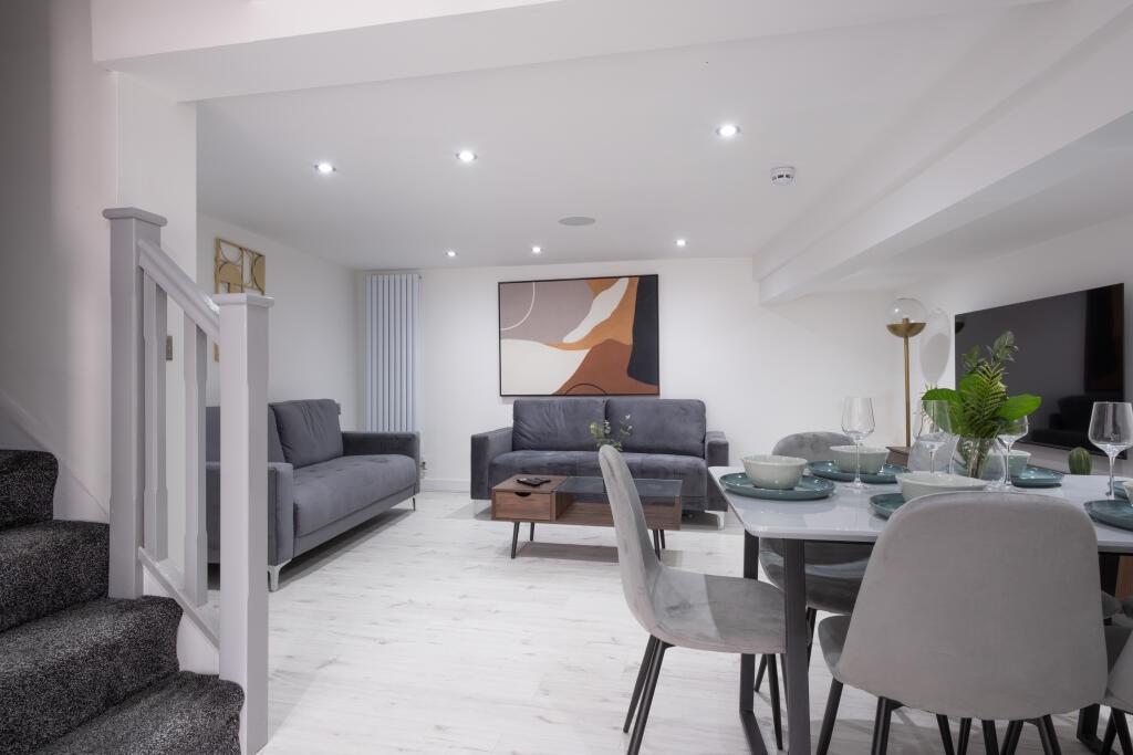 A modern and stylish living room featuring comf...