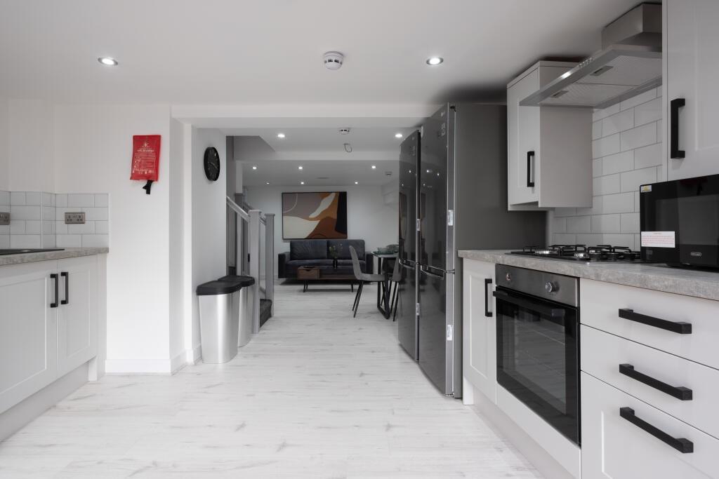 Bright and modern kitchen featuring sleek white...