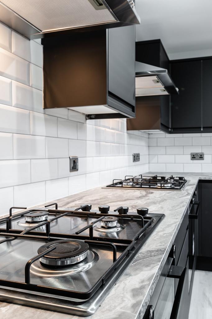 Modern kitchen featuring a marble countertop, w...