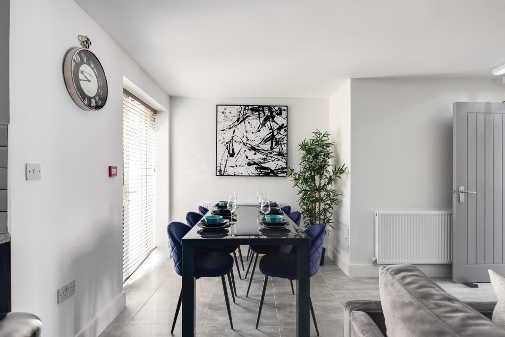 Bright and modern living room featuring a large...