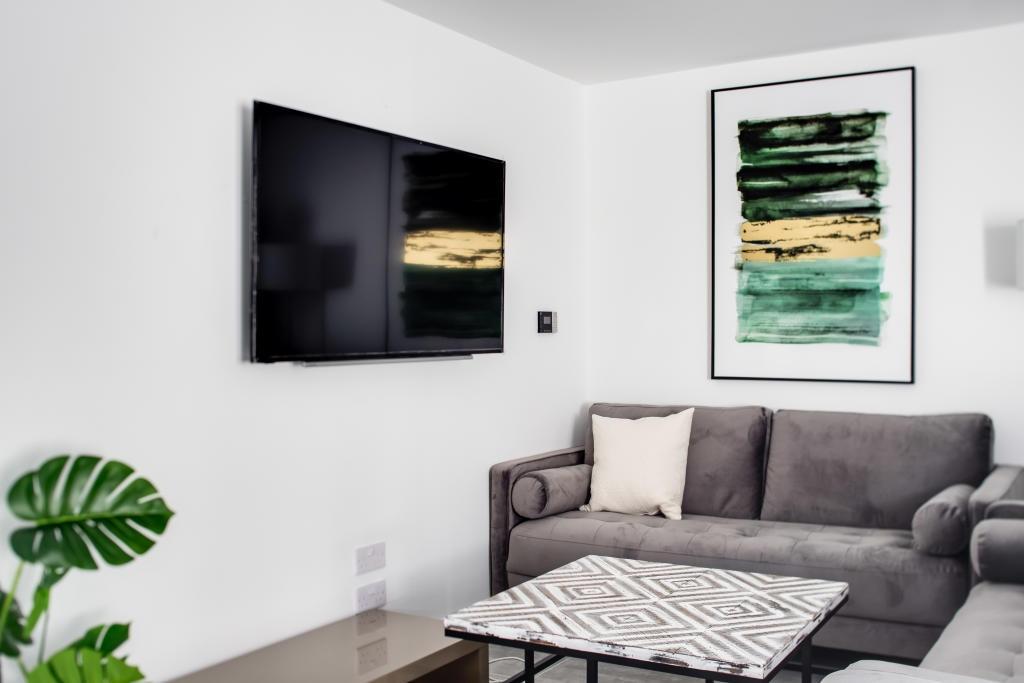 A modern, well-lit living room featuring a comf...