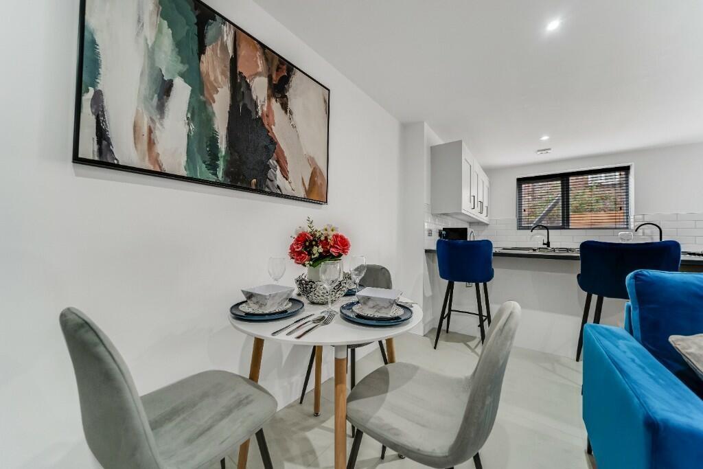 A bright and modern living room featuring conte...