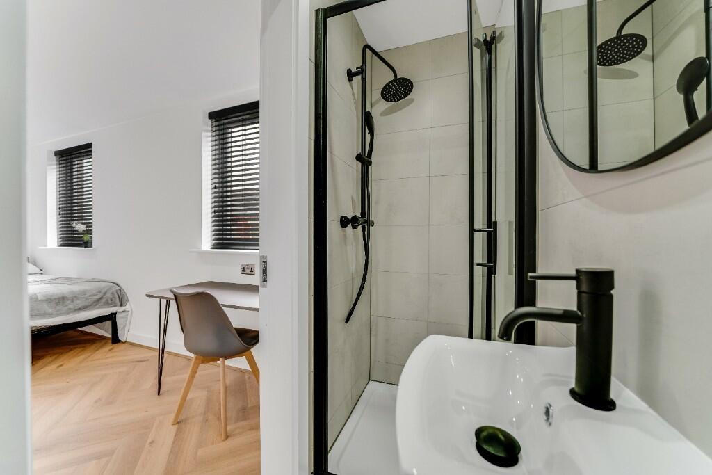 A modern and clean bathroom suite featuring a s...