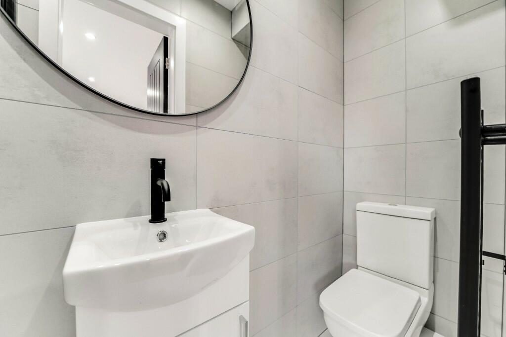 A bright and modern bathroom featuring a white ...