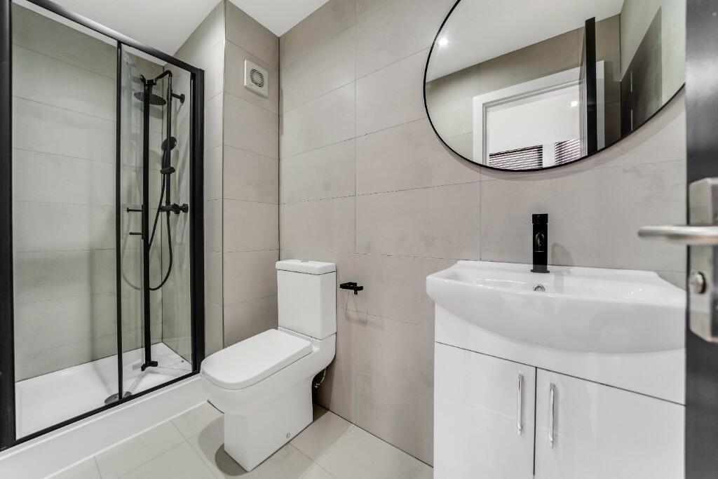 Modern, well-maintained bathroom with sleek fix...