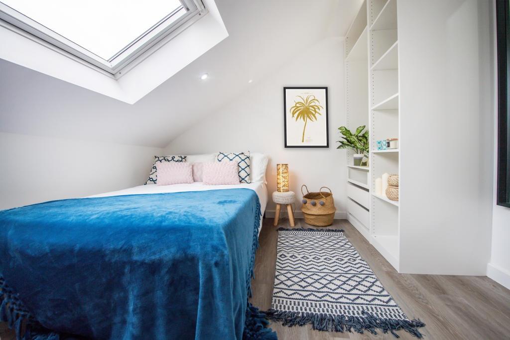 Bright and spacious master bedroom featuring a ...