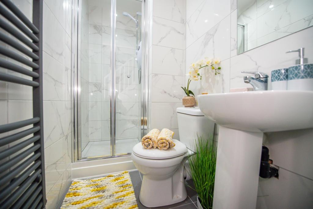 A modern, clean bathroom featuring a spacious s...