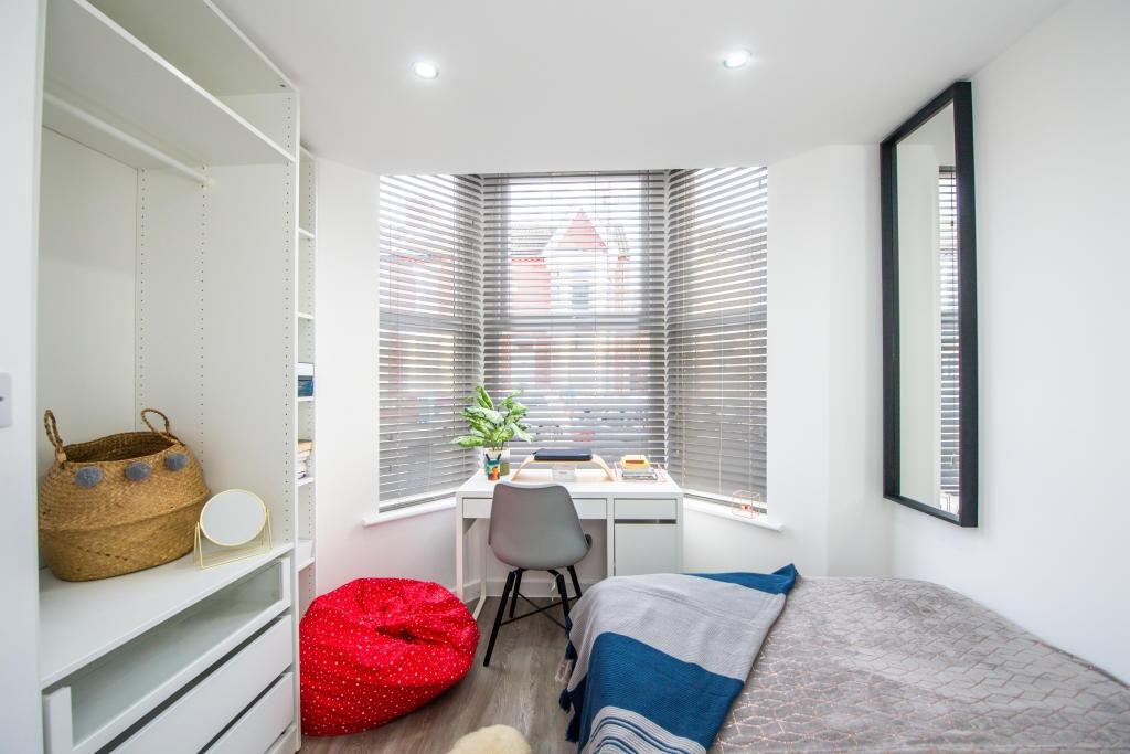 Bright and inviting living area with large wind...