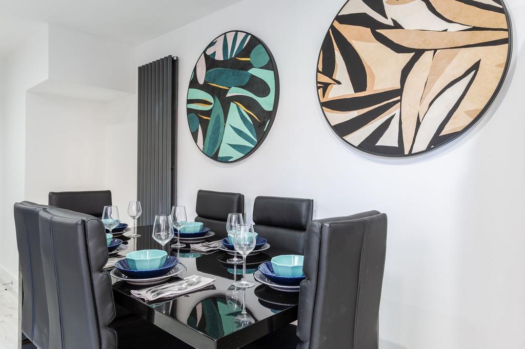 Modern and stylish dining area with a sleek bla...