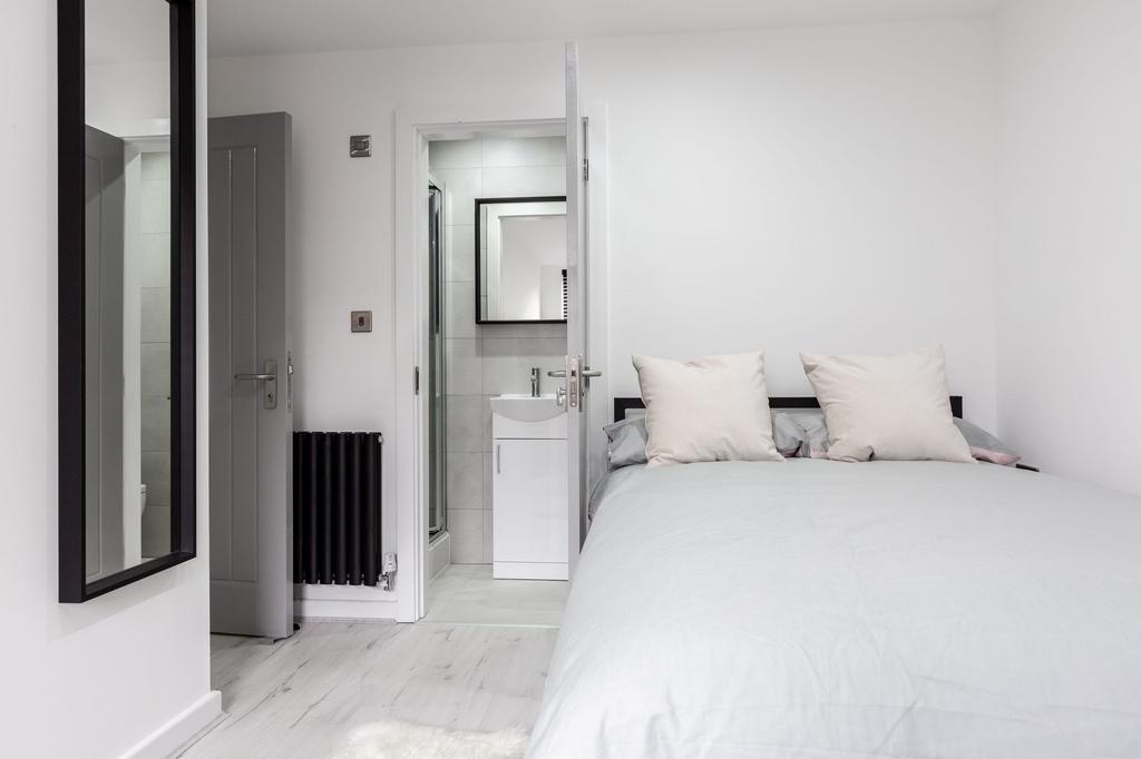 A bright and inviting master bedroom featuring ...