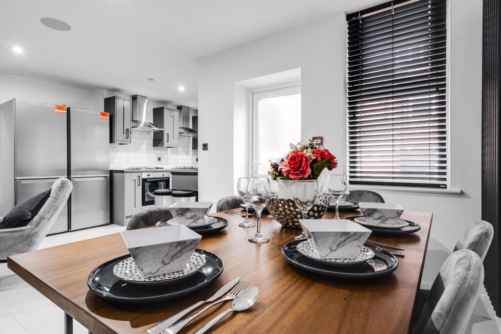 Modern and well-lit kitchen with ample natural ...