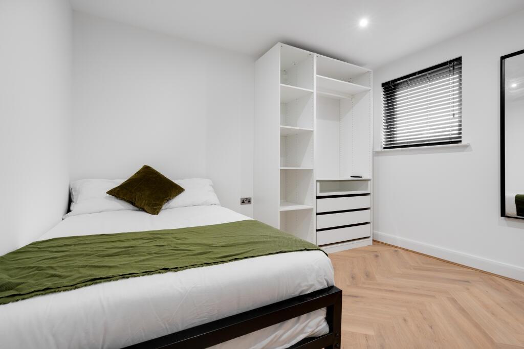 A bright and modern master bedroom featuring a ...