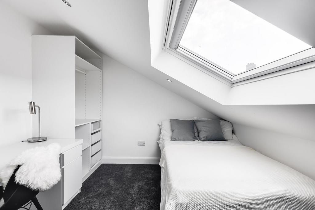 Bright and minimalist single bedroom featuring ...