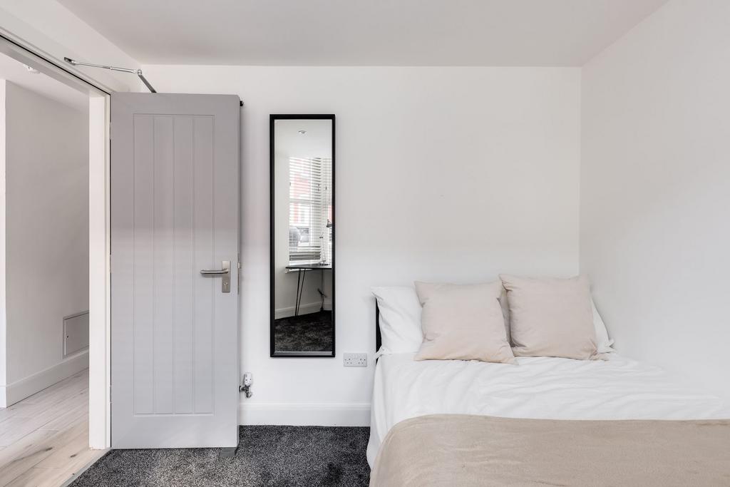 A bright and tidy student bedroom featuring a n...