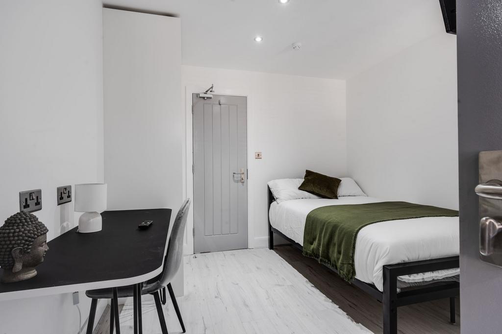 A modern, well-maintained student room featurin...