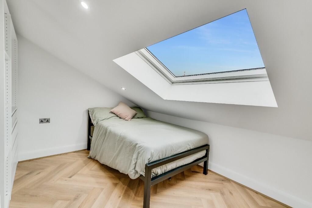 Bright and airy master bedroom featuring a comf...