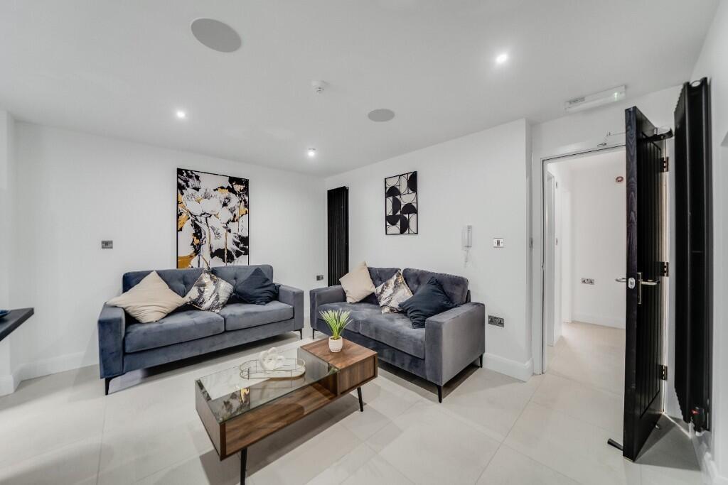A bright, spacious living room with modern furn...