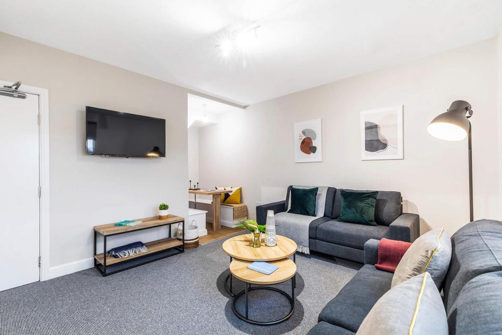 Bright, modern communal living area with comfor...