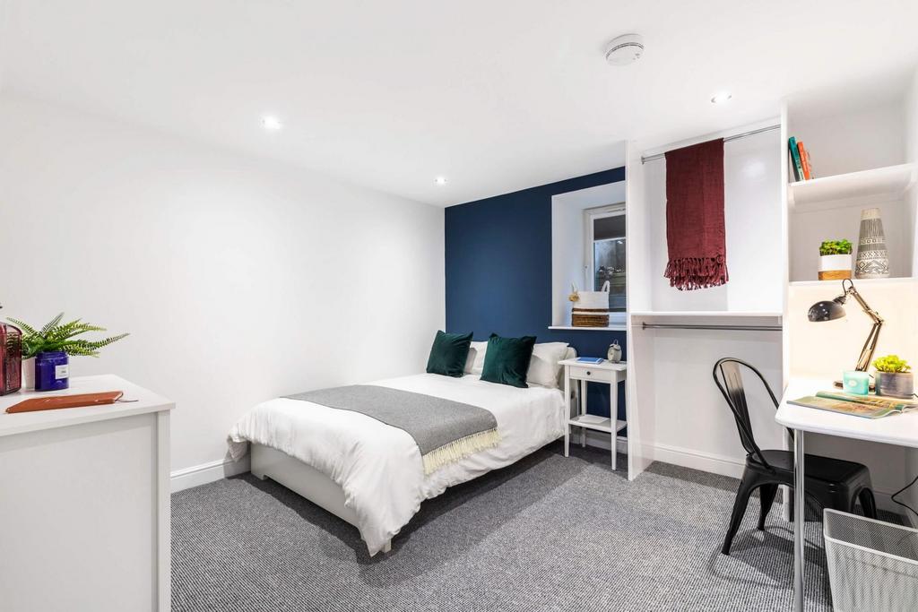 Bright, modern bedroom with a comfortable doubl...