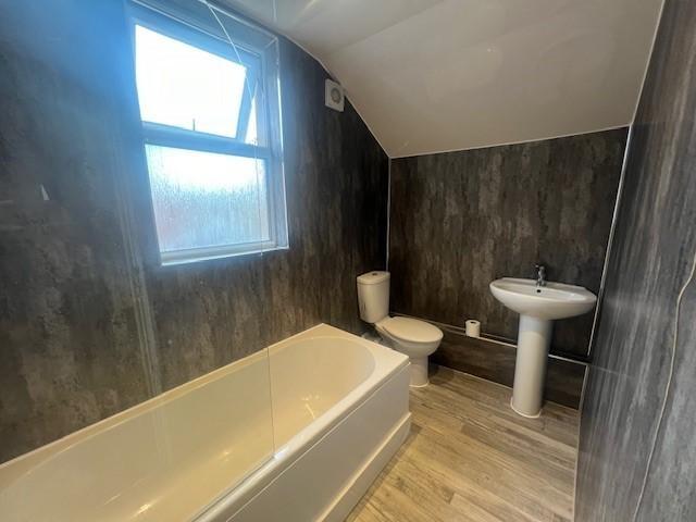 Modern bathroom with a full-size bathtub, pedes...