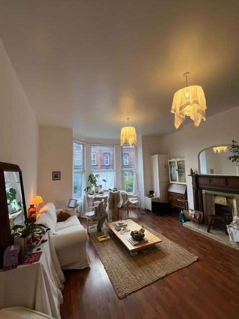Bright, inviting living room with high ceilings...