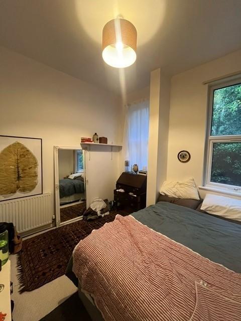 Cozy double bedroom with a neatly made bed, bed...