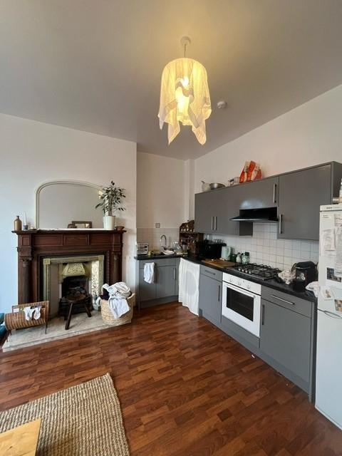 Bright combined kitchen-living area with modern...