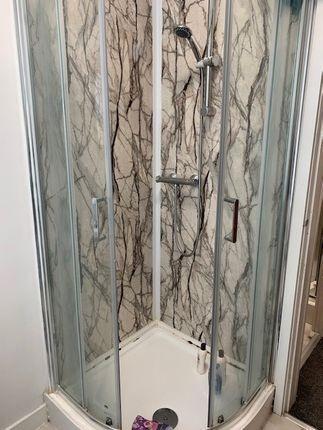 Modern corner shower enclosure with clear glass...