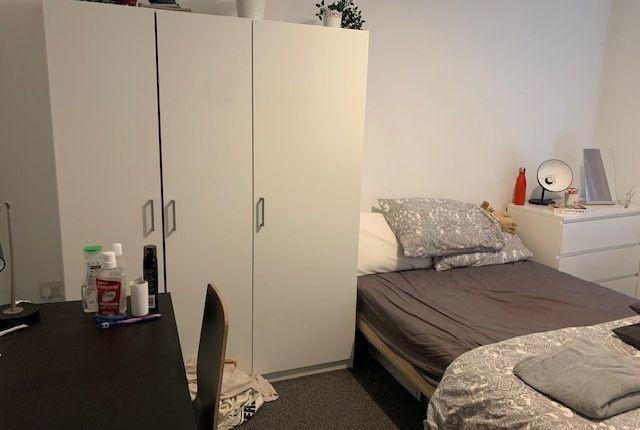 Bright, simply furnished bedroom with a double ...