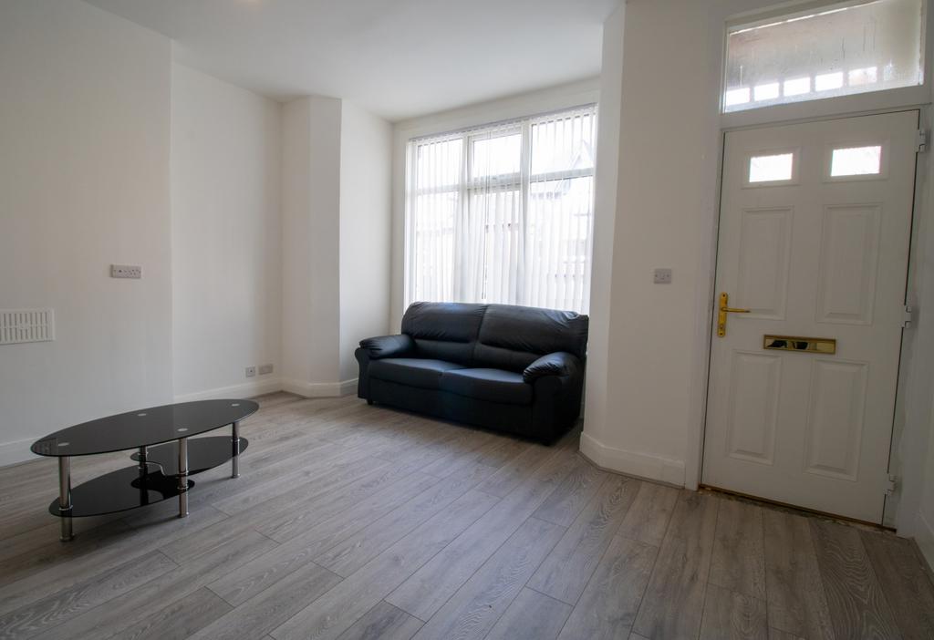 Bright ground-floor living room with a large fr...