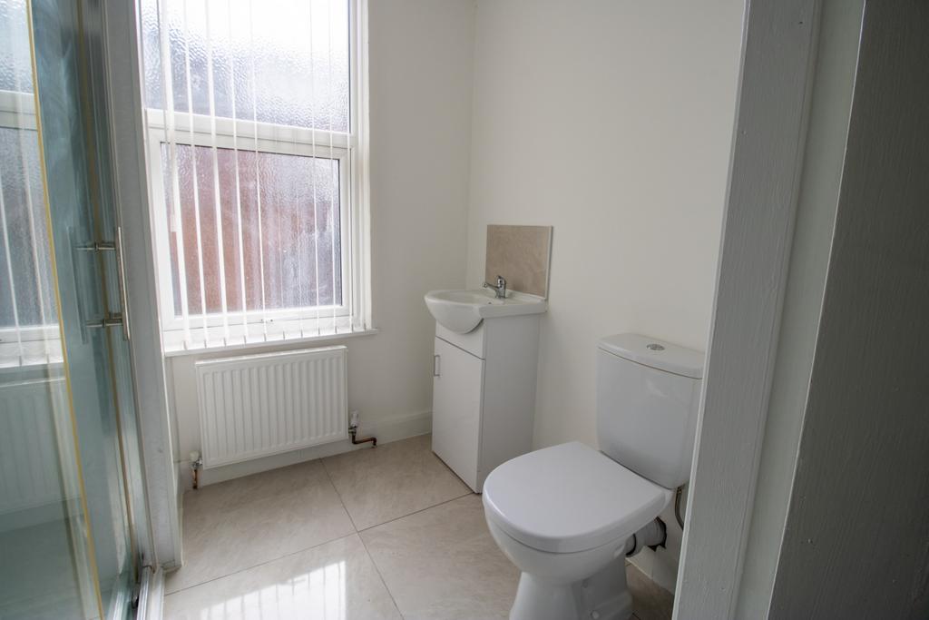 Bright, modern bathroom with a clean white toil...