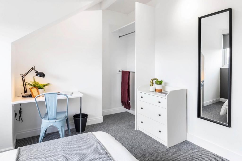 Bright, modern bedroom with a comfortable bed, ...