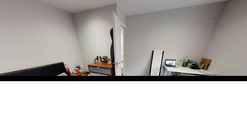 Compact, simply furnished bedroom with neutral ...