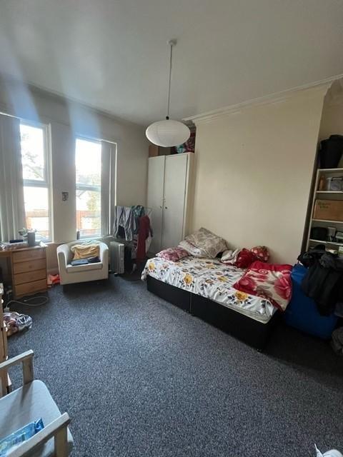 Bright, well-appointed bedroom with large sash ...