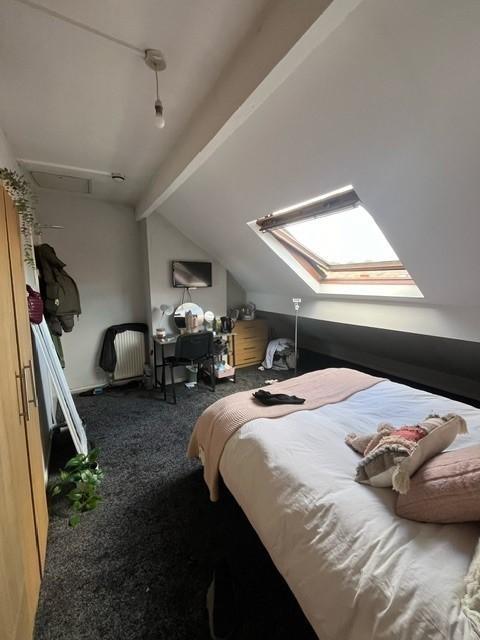 Bright attic double bedroom with a skylight, do...
