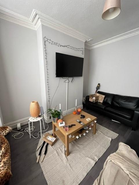Contemporary living room with a wall-mounted TV...