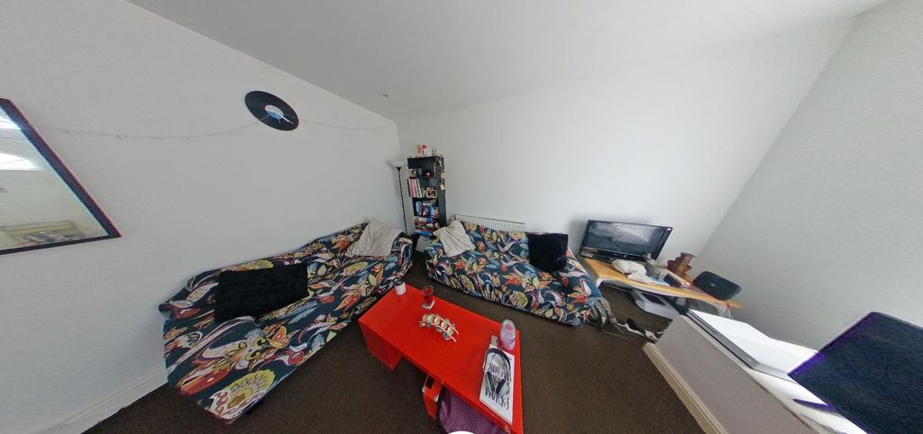Bright, simply furnished bedroom with a comfort...