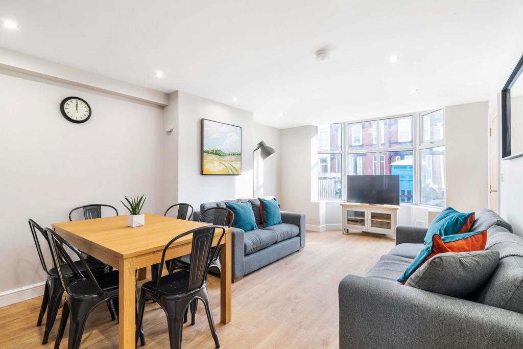 Bright, modern open-plan living area with large...