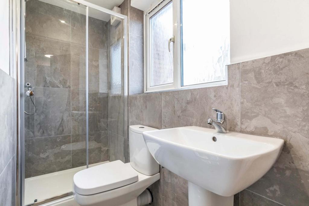 Modern bathroom with a walk-in shower, pedestal...