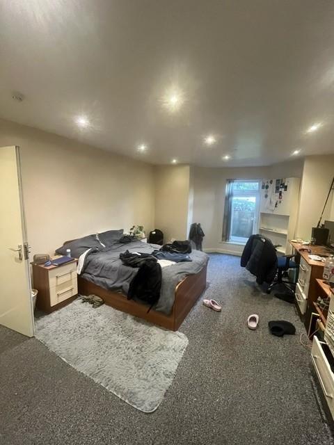 Spacious, well-lit master bedroom with a double...