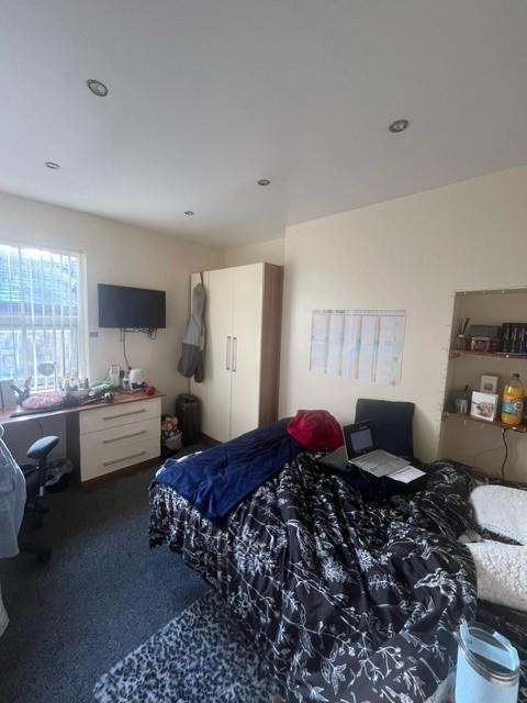 Bright, well-appointed bedroom featuring a larg...